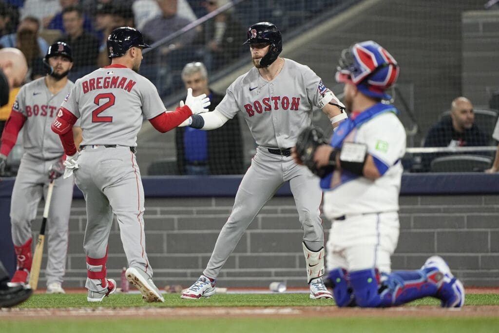 Apr 29, 2025; Toronto, Ontario, CAN; Boston Red Sox shortstop Trevor Story (10) congratulates third baseman Alex Bregman (2) on his solo home run against the Toronto Blue Jays during the first inning at Rogers Centre.