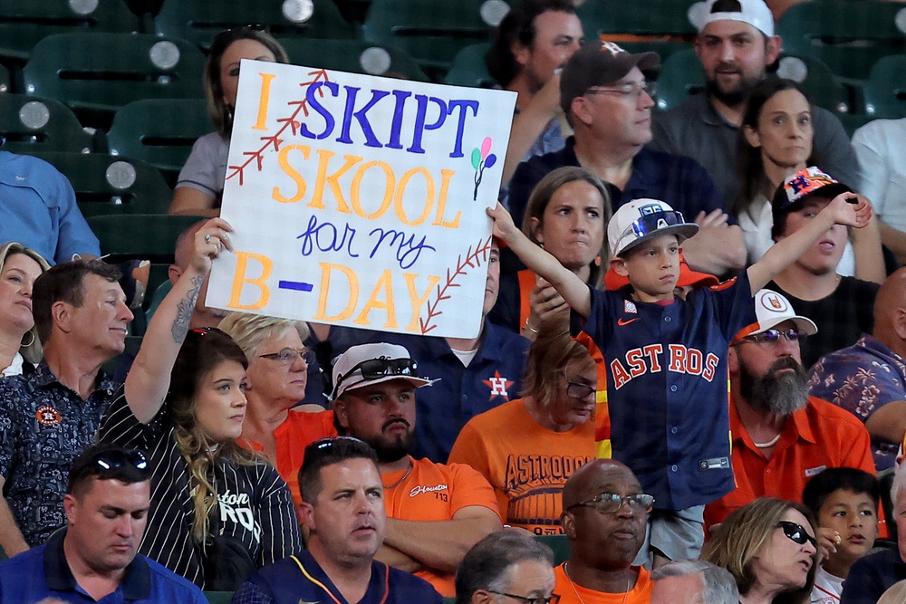 Apr 30, 2025; Houston, Texas, USA; A young Houston Astros fan holds up a sign during the fifth inning against the Detroit Tigers at Daikin Park.