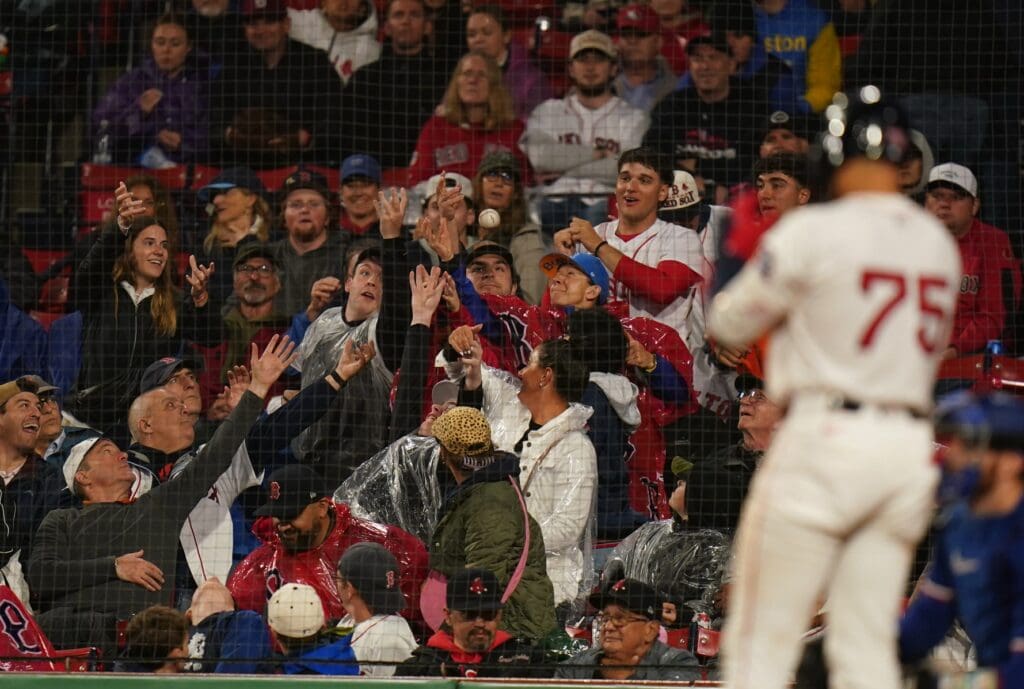 May 6, 2025; Boston, Massachusetts, USA; Fans work for the ball as the Boston Red Sox take on the Texas Rangers in the fifth inning at Fenway Park