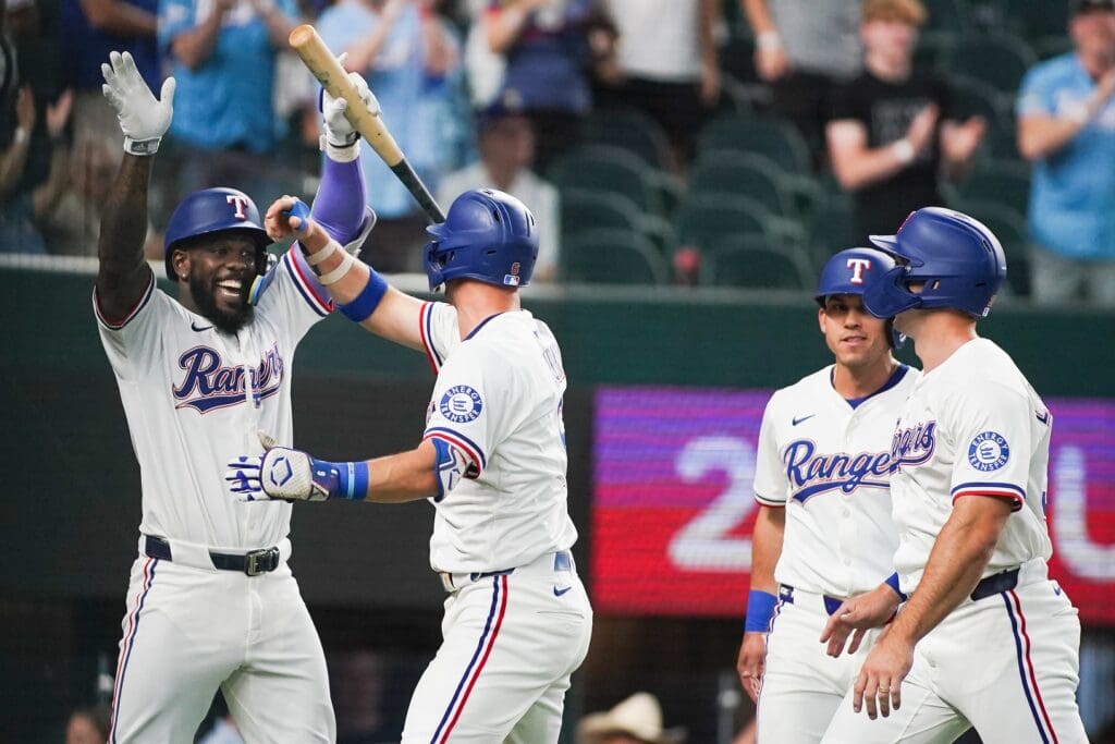 May 13, 2025; Arlington, Texas, USA; Texas Rangers third baseman Josh Jung (6) is greeted by outfielder Adolis García (53) after hitting a three-run home run scoring outfielder Sam Haggerty (0) and outfielder Evan Carter (32) during the first inning against the Colorado Rockies at Globe Life Field.