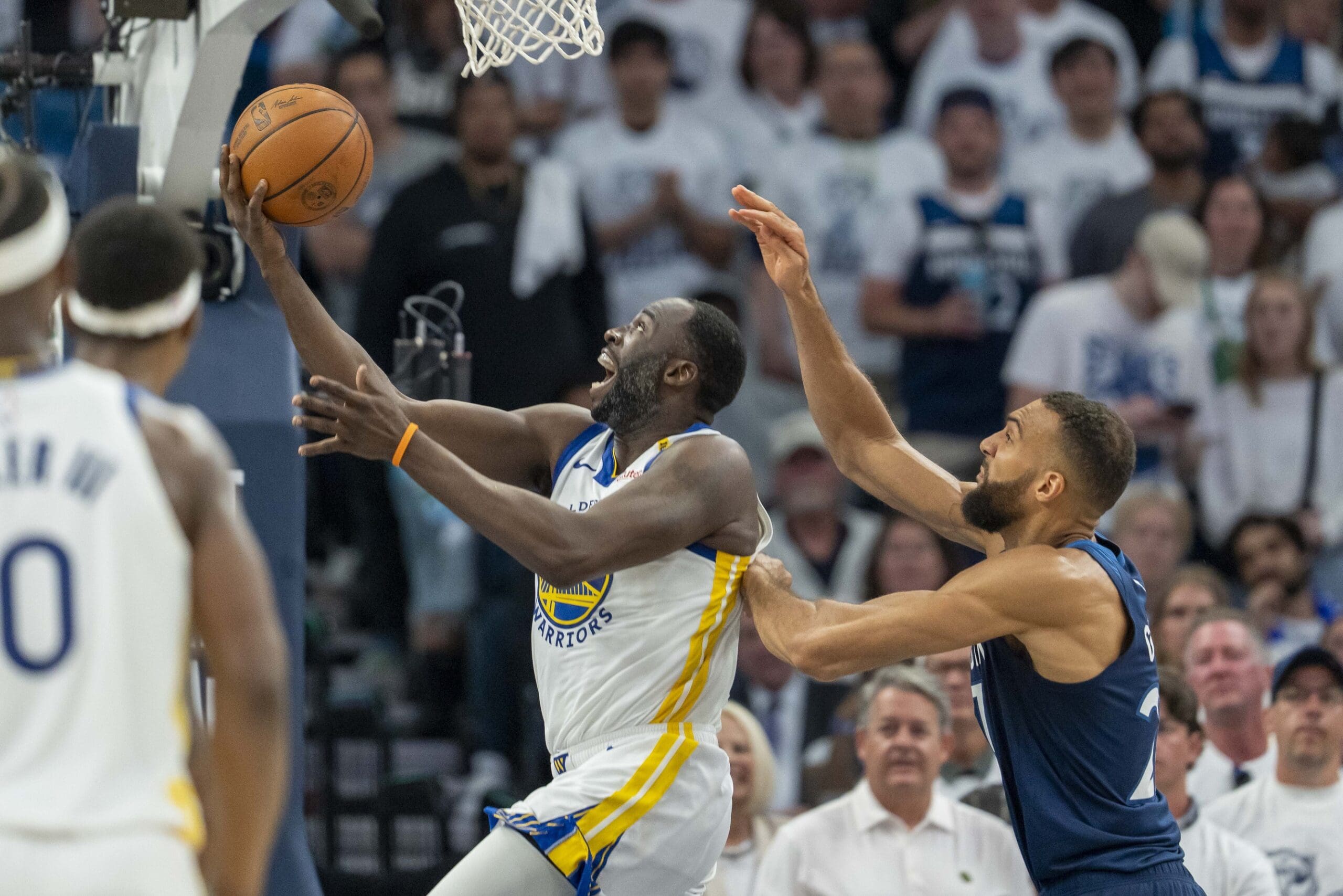 May 14, 2025; Minneapolis, Minnesota, USA; Golden State Warriors forward Draymond Green (23) drives to the basket past Minnesota Timberwolves center Rudy Gobert (27) in the first half during game five of the second round for the 2025 NBA Playoffs at Target Center. Mandatory Credit: Jesse Johnson-Imagn Images