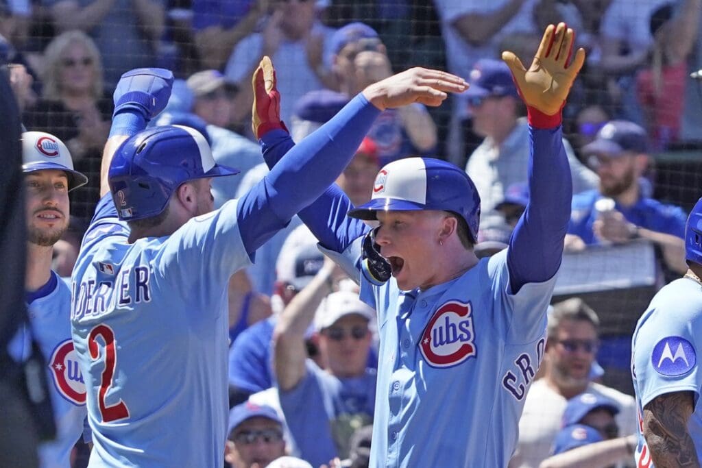 May 16, 2025; Chicago, Illinois, USA; Chicago Cubs outfielder Pete Crow-Armstrong (4) is greeted by second base Nico Hoerner (2) after hitting a three run home run against the Chicago White Sox during the second inning at Wrigley Field.