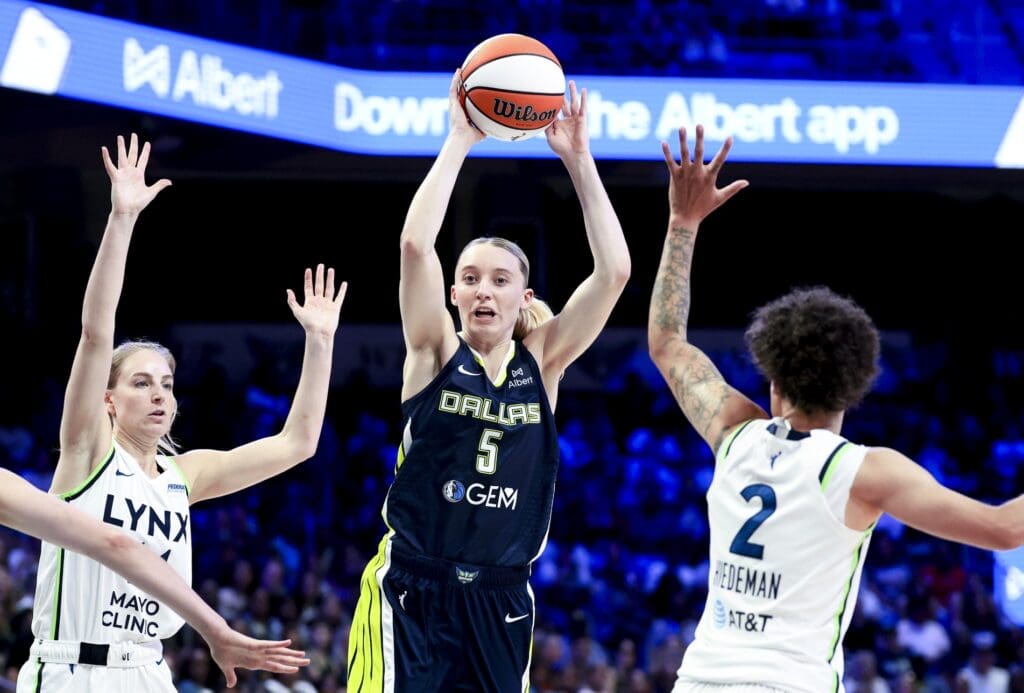 May 16, 2025; Arlington, Texas, USA; Dallas Wings guard Paige Bueckers (5) passes over Minnesota Lynx guard Natisha Hiedeman (2) during the second half at College Park Center.