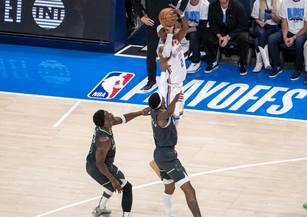 May 20, 2025; Oklahoma City, Oklahoma, USA; Oklahoma City Thunder guard Shai Gilgeous-Alexander (2) shoots against Minnesota Timberwolves guard Anthony Edwards (5) and forward Jaden McDaniels (3) during game one of the western conference finals for the 2025 NBA Playoffs at Paycom Center.