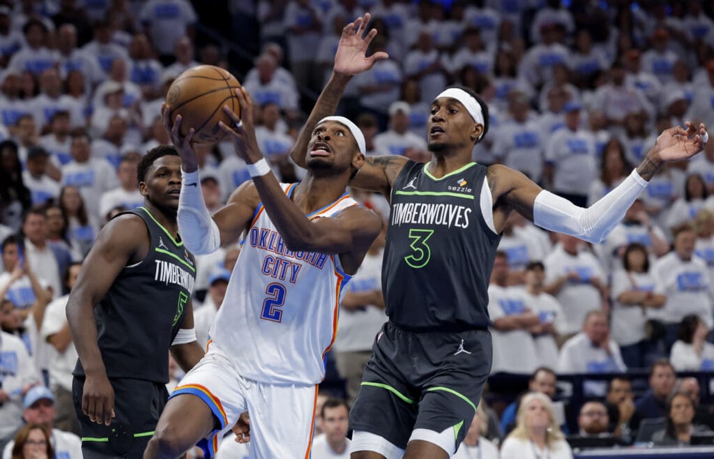 May 20, 2025; Oklahoma City, Oklahoma, USA; Oklahoma City Thunder guard Shai Gilgeous-Alexander (2) drives against Minnesota Timberwolves forward Jaden McDaniels (3) in the fourth quarter during game one of the western conference finals for the 2025 NBA Playoffs at Paycom Center.
