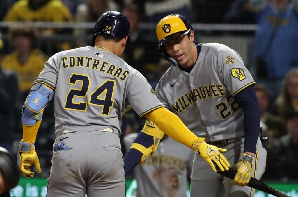 May 23, 2025; Pittsburgh, Pennsylvania, USA; Milwaukee Brewers designated hitter Christian Yelich (22) congratulates catcher William Contreras (24) crossing home plate on a solo home run against the Pittsburgh Pirates during the ninth inning at PNC Park