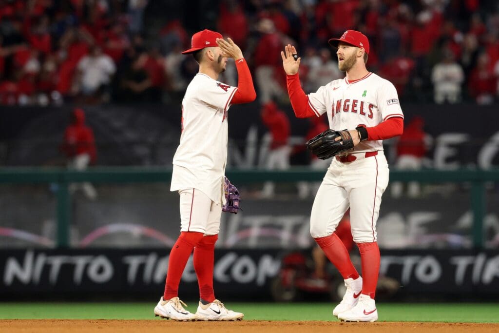 May 23, 2025; Anaheim, California, USA; Los Angeles Angels shortstop Zach Neto (9, left) and left fielder Taylor Ward (3, right) celebrate a win after defeating the Miami Marlins at Angel Stadium.