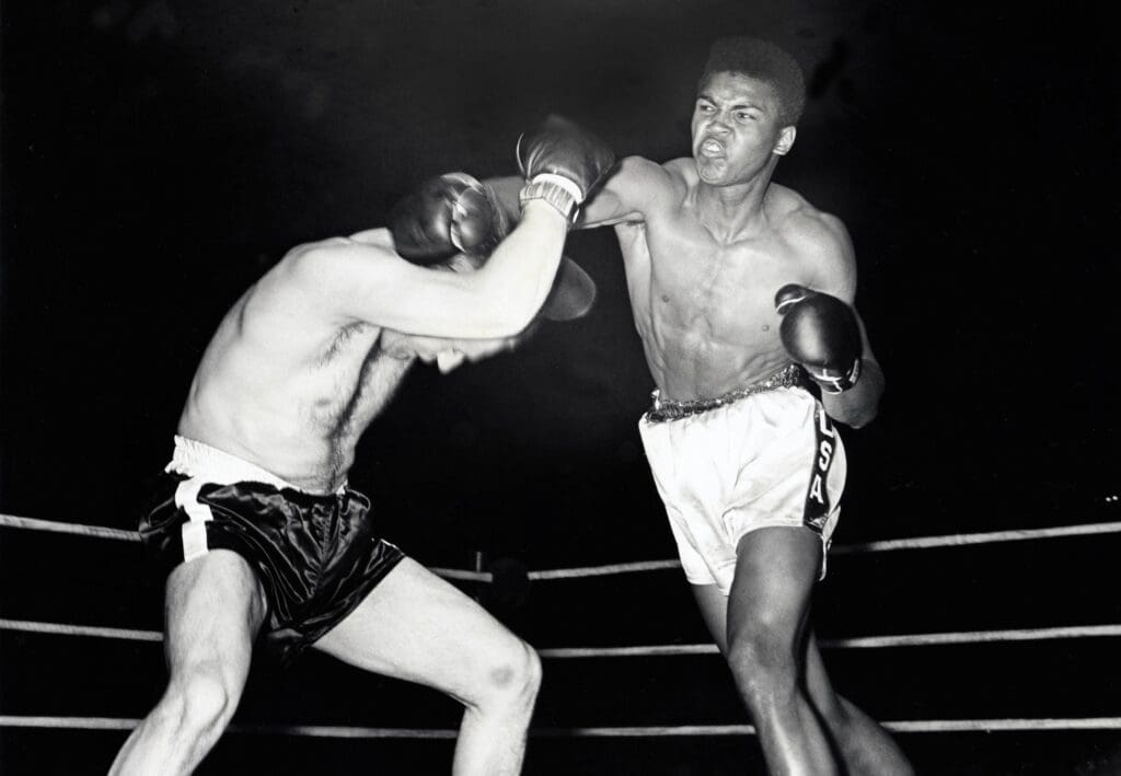 Apr 19, 1961; Louisville, KY, USA: FILE PHOTO; Cassius Clay a/k/a Muhammad Ali connects with the right hand against Lamar Clark at Freedom Hall.