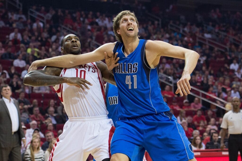 Nov 22, 2014; Houston, TX, USA; Houston Rockets forward Tarik Black (10) and Dallas Mavericks forward Dirk Nowitzki (41) during the game at the Toyota Center. The Rockets defeated the Mavericks 95-92. Mandatory Credit: Jerome Miron-USA TODAY Sports