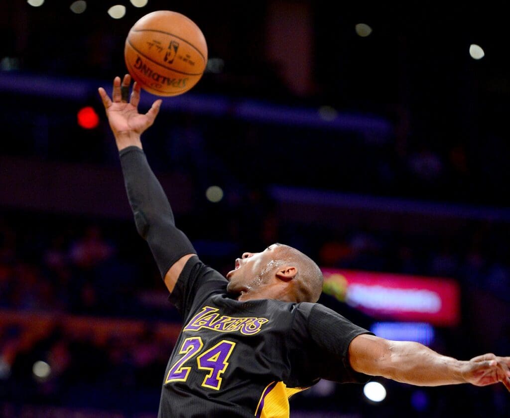 Mar 25, 2016; Los Angeles, CA, USA; Los Angeles Lakers forward Kobe Bryant (24) reaches for a rebound in the first quarter of the game against the Denver Nuggets at Staples Center