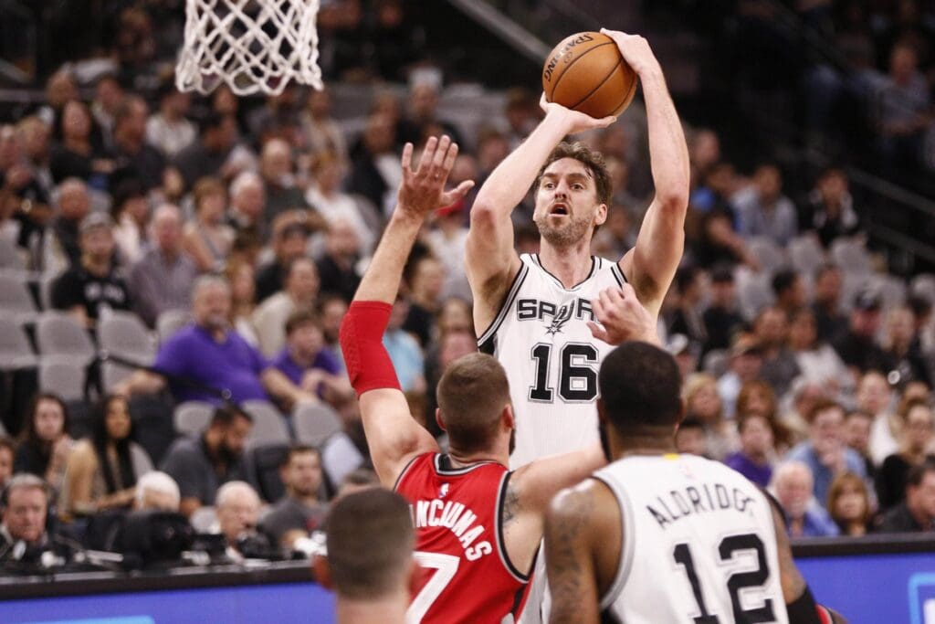 Jan 3, 2017; San Antonio, TX, USA; San Antonio Spurs center Pau Gasol (16) shoots the ball over Toronto Raptors center Jonas Valanciunas (17) during the first half at AT&T Center.