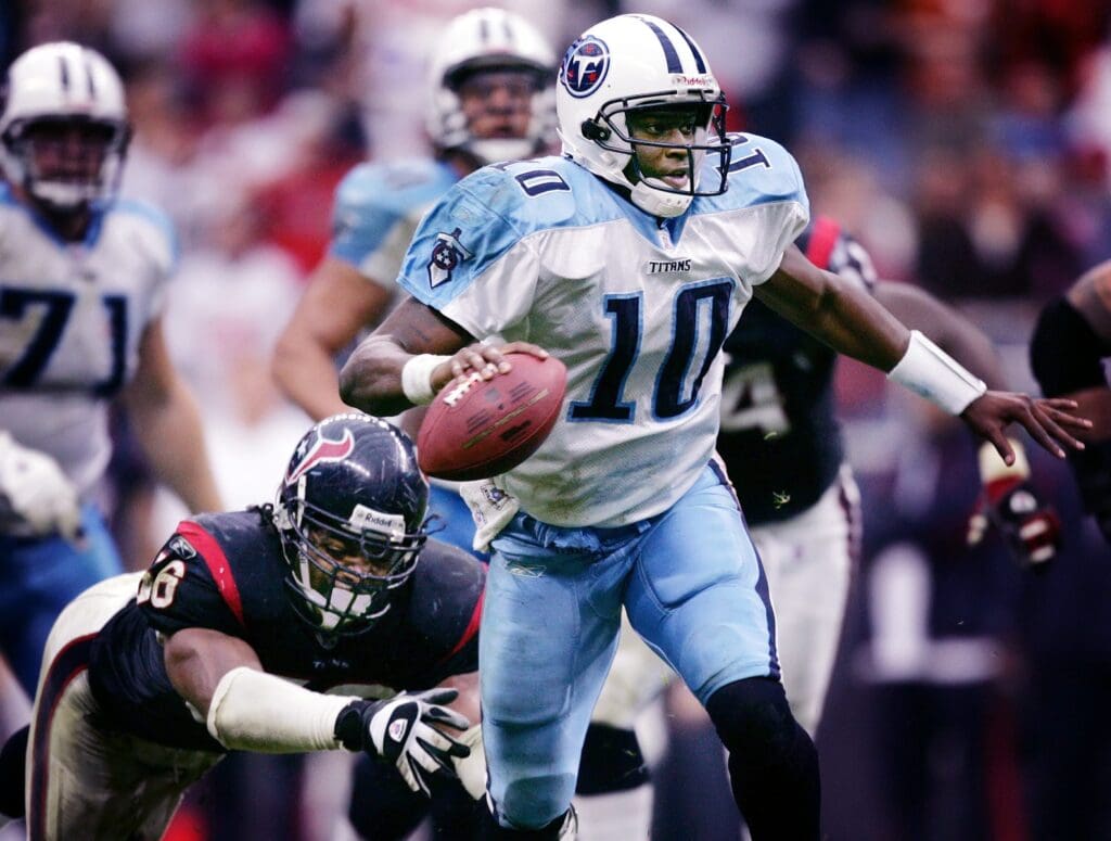 Tennessee Titans rookie quarterback Vince Young (10) breaks away from Houston Texans linebacker Morlon Greenwood (56) to score the game winning touchdown on a 39-yard run in overtime at Reliant Stadium in Houston, Texas, on Dec. 10, 2006.