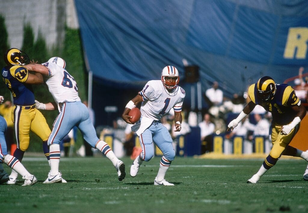 Dec 9, 1984; Anaheim, CA, USA; FILE PHOTO; Houston Oilers quarterback Warren Moon (1) and guard Mike Munchak (63) in action against Los Angeles Rams defensive linemen Reggie Doss (71) and Reggie Doss (77) at Anaheim Stadium. Mandatory Credit: Peter Brouillet-USA TODAY NETWORK