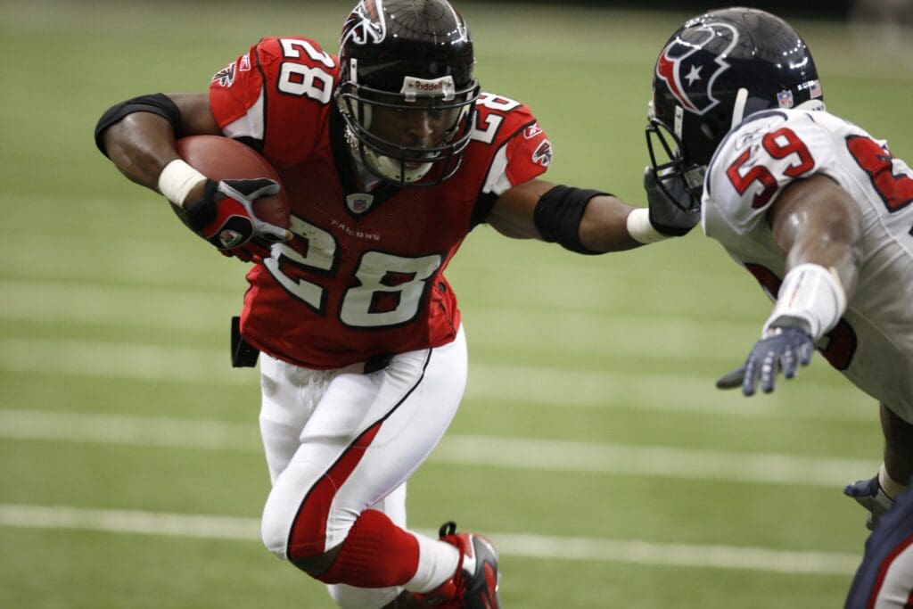 September 30, 2007; Atlanta, GA, USA; Atlanta Falcons running back (28) Warrick Dunn collides with Houston Texans linebacker (59) DeMeco Ryans on a run play in the second quarter at the Georgia Dome. The Falcons defeated the Texans 26 to 16 at the Georgia Dome.