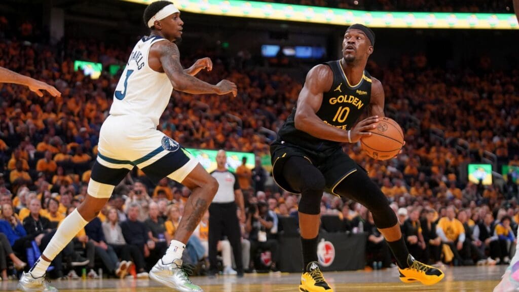 Golden State Warriors forward Jimmy Butler III (10) holds onto the ball next to Minnesota Timberwolves forward Jaden McDaniels (3) in the third quarter during game four of the second round for the 2025 NBA Playoffs at Chase Center.