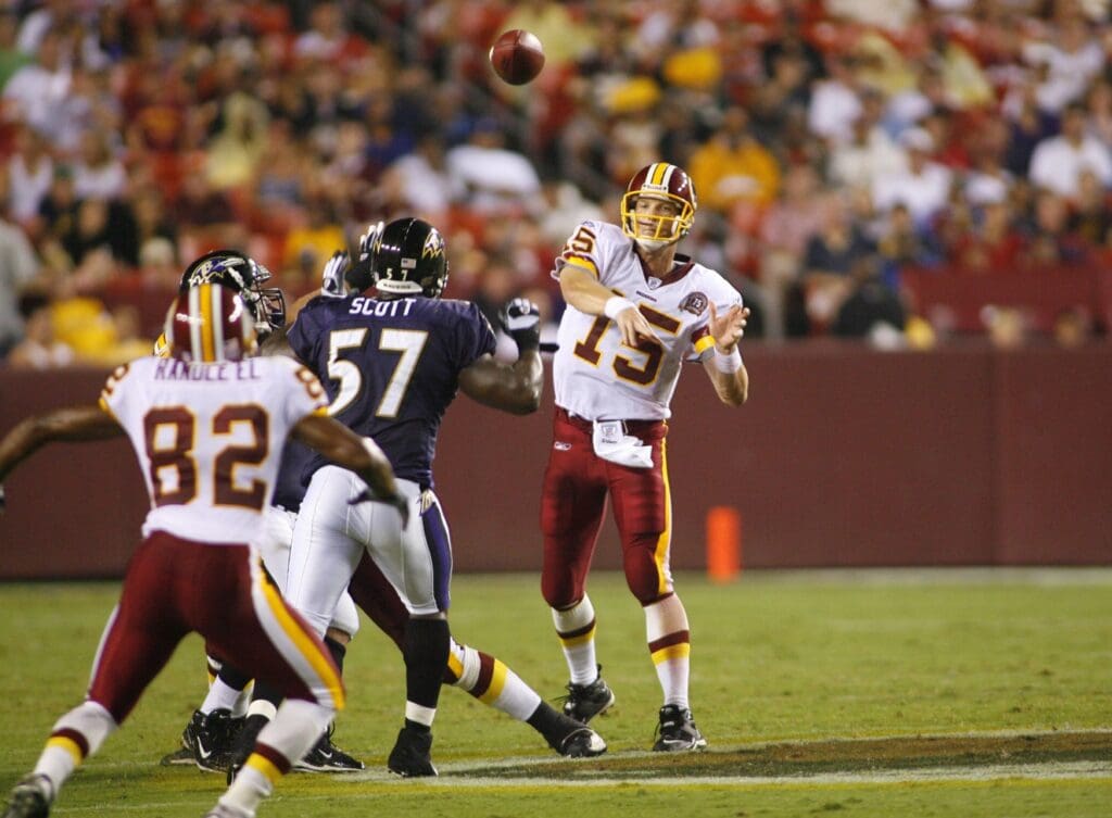 Aug 25, 2007; Landover, MD, USA; Washington Redskins quarterback (15) Todd Collins throws to wide receiver (82) Antwaan Randle El as Baltimore Ravens linebacker (57) Bart Scott applies pressure in the second quarter during a preseason game at FedEx Field in Landover, MD.