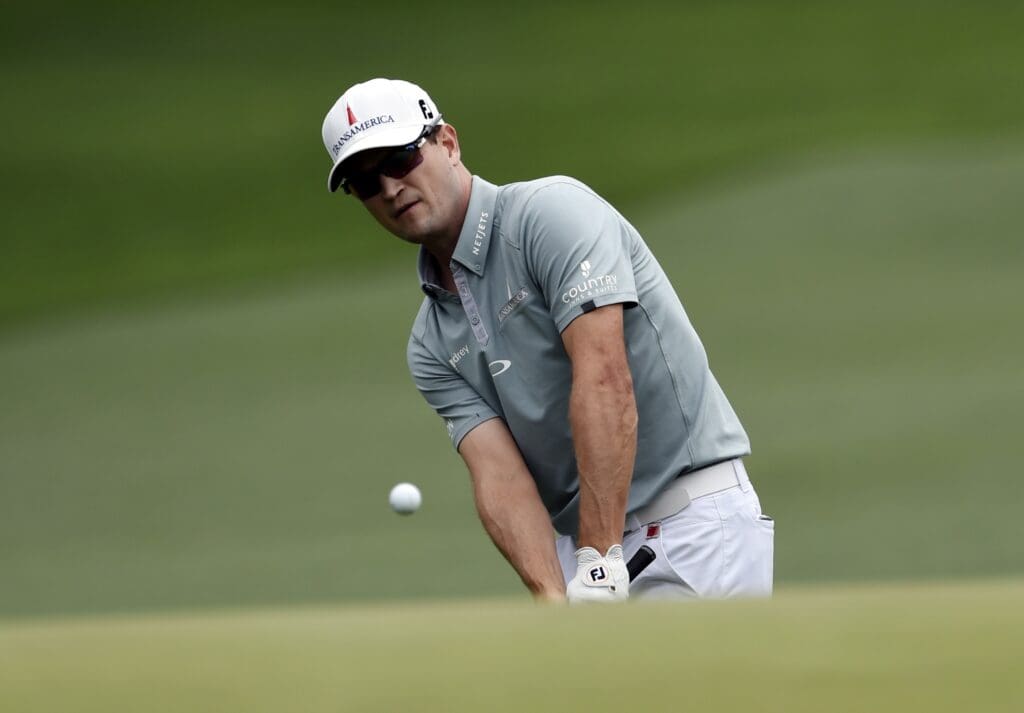 Apr 12, 2015; Augusta, GA, USA; Zach Johnson chips onto the 1st green during the final round of The Masters golf tournament at Augusta National Golf Club.