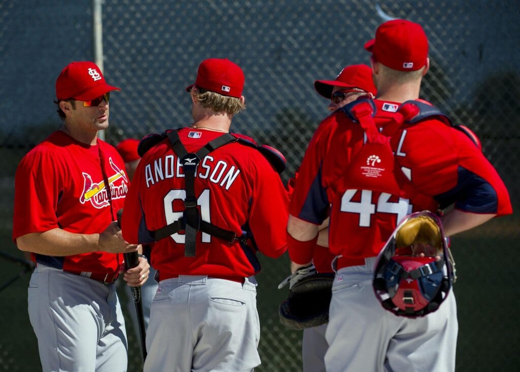 Feb 23, 2011; Jupiter, FL, USA; St. Louis Cardinals manager Mike Matheny (22) talks with catchers during spring training at Roger Dean Stadium
