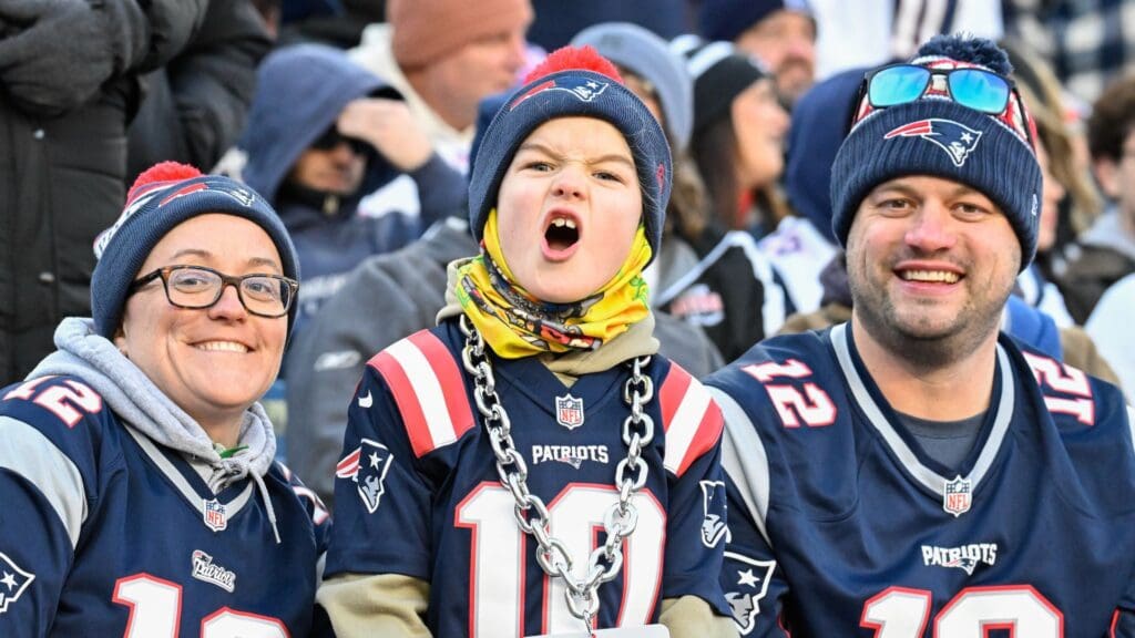 Dec 1, 2024; Foxborough, Massachusetts, USA; A young New England Patriots fan cheers for the team during the first half against the Indianapolis Colts at Gillette Stadium.