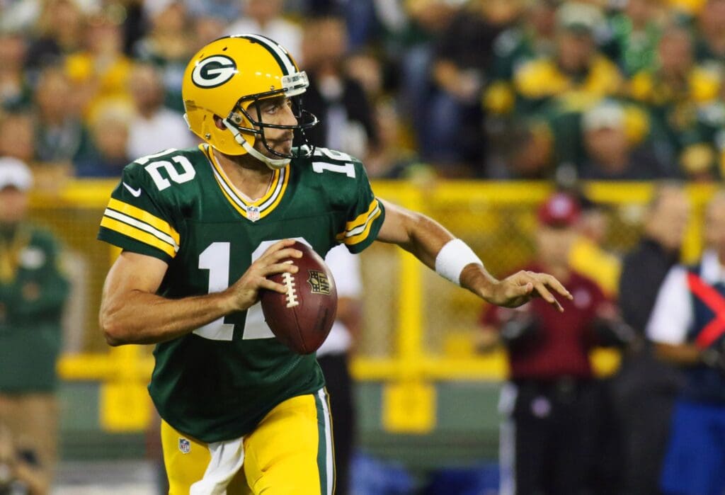 Sep 20, 2015; Green Bay, WI, USA; Green Bay Packers quarterback Aaron Rodgers (12) passes against the Seattle Seahawks during the first quarter at Lambeau Field. Packers won 27-17.