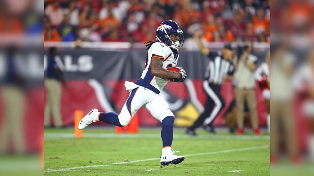 Aug 30, 2018; Glendale, AZ, USA; Denver Broncos cornerback Adam Jones (20) returns the ball against the Arizona Cardinals during a pre season game at University of Phoenix Stadium.