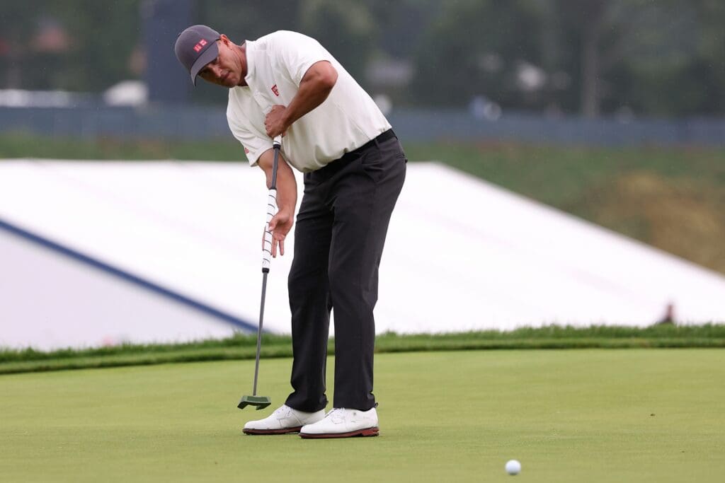 Jun 15, 2025; Oakmont, Pennsylvania, USA; Adam Scott putts on the 13th green during the final round of the U.S. Open golf tournament.
