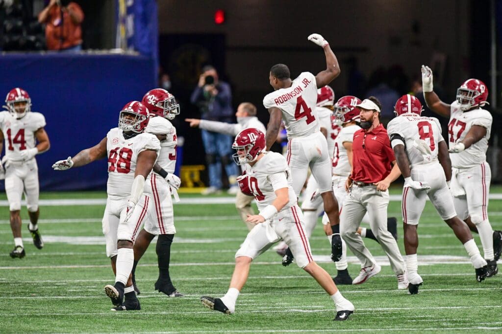 Alabama Crimson Tide quarterback Mac Jones (10) celebrates with teammates after defeating the Florida Gators at Mercedes-Benz Stadium.