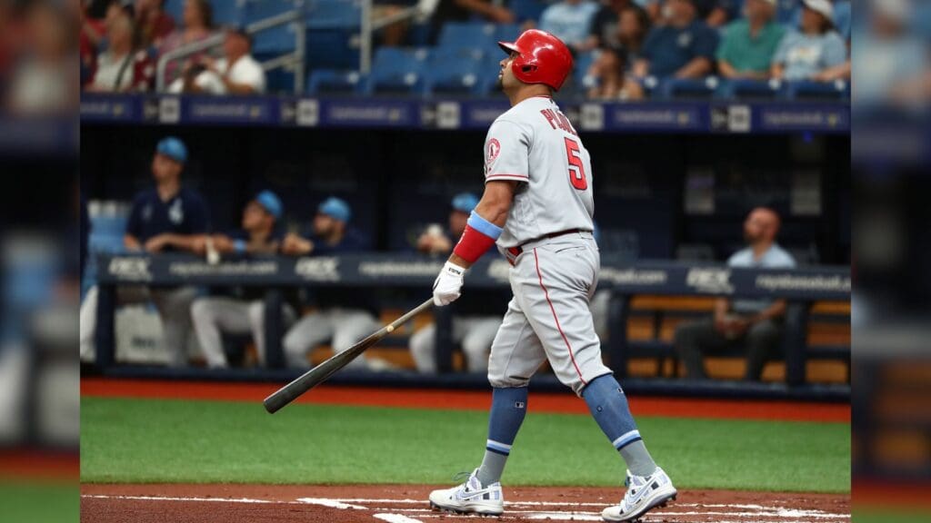 Jun 16, 2019; St. Petersburg, FL, USA; Los Angeles Angels first baseman Albert Pujols (5) hits a sacrifice RBI against the Tampa Bay Rays during the first inning at Tropicana Field.