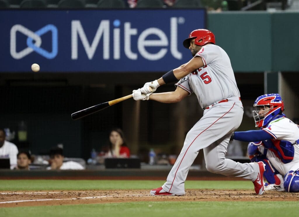 Apr 26, 2021; Arlington, Texas, USA; Los Angeles Angels first baseman Albert Pujols (5) hits a home run during the fourth inning against the Texas Rangers at Globe Life Field.