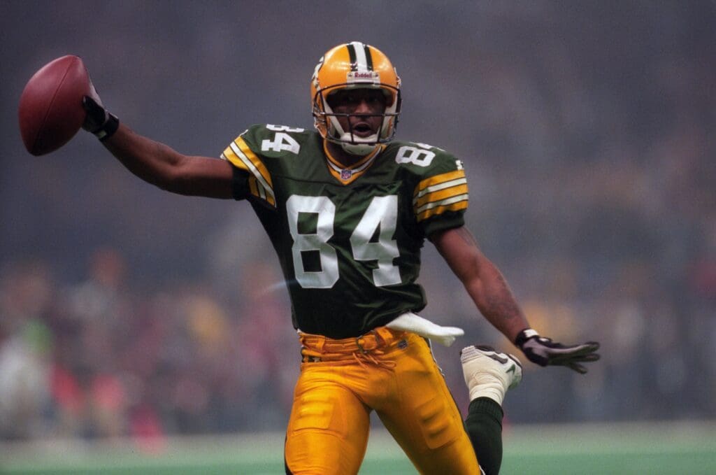 Jan 26, 1997; New Orleans, LA, USA; FILE PHOTO; Green Bay Packers receiver Andre Rison (84) catches a pass for a touchdown reception against the New England Patriots during Super Bowl XXXI at the Superdome. The Packers defeated the Patriots 35-21.