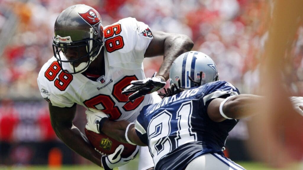 September 13, 2009; Tampa, FL, USA; Dallas Cowboys cornerback Mike Jenkins (21) attempts to tackle Tampa Bay Buccaneers wide receiver Antonio Bryant (89) during the first half at Raymond James Stadium.