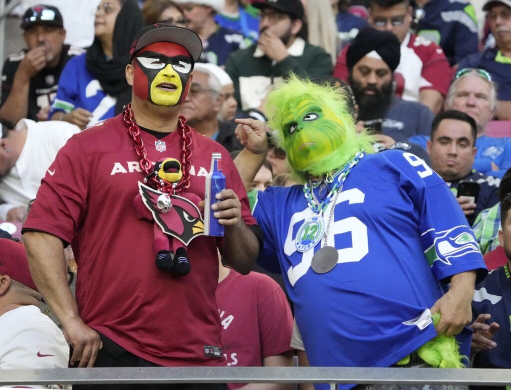 An Arizona Cardinals and Seattle Seahawks fan chat during the third quarter at State Farm Stadium.