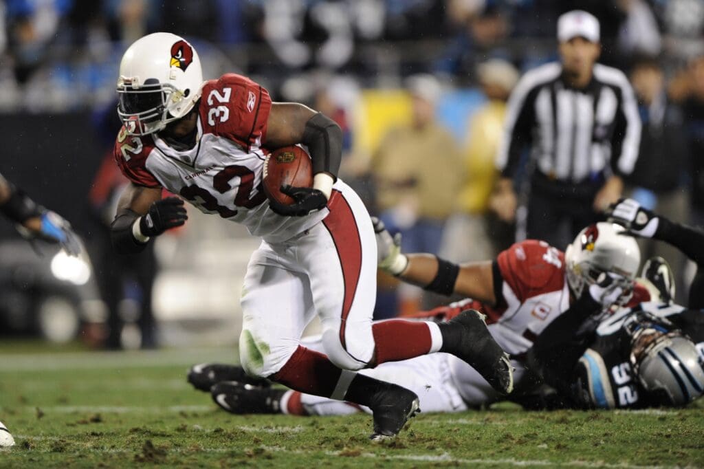 Jan 10, 2009; Charlotte, NC, USA; Arizona Cardinals running back Edgerrin James (32) scores a touchdown in the first quarter as Carolina Panthers defensive tackle Damione Lewis (92) defends at Bank of America Stadium