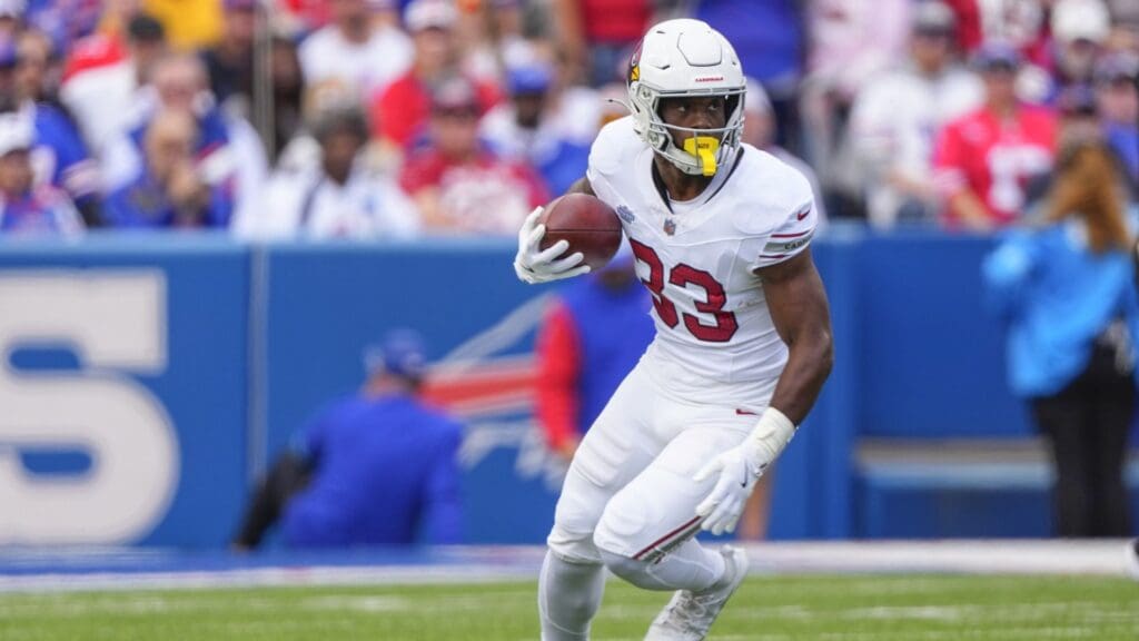 Sep 8, 2024; Orchard Park, New York, USA; Arizona Cardinals running back Trey Benson (33) runs with the ball after making a catch against the Buffalo Bills during the first half at Highmark Stadium.