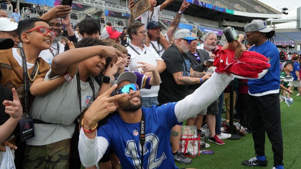 Feb 1, 2025; Orlando, FL, USA; Atlanta Falcons special teams player KhaDarel Hodge (12) poses with fans during NFC Practice for the Pro Bowl Games at Camping World Stadium.