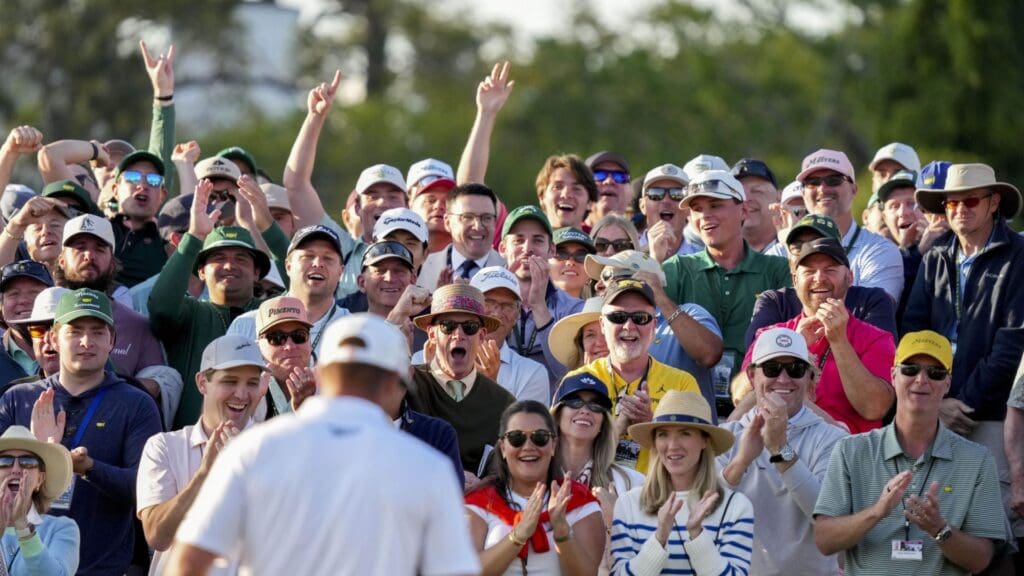 Apr 12, 2025; Augusta, Georgia, USA; Fans cheer for Bryson DeChambeau on the no. 18 green during the third round of the Masters Tournament at Augusta National Golf Club
