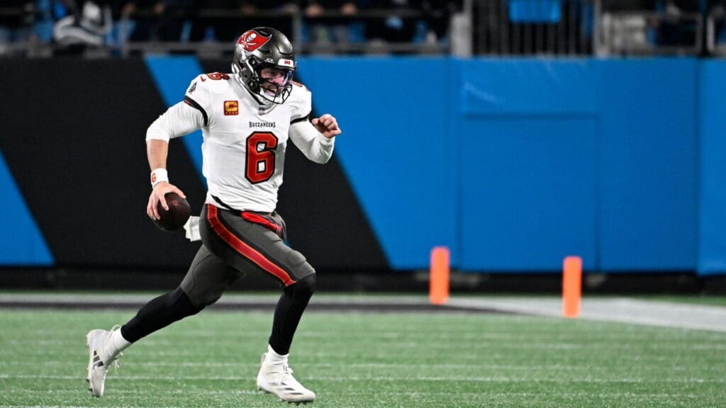 Dec 1, 2024; Charlotte, North Carolina, USA; Tampa Bay Buccaneers quarterback Baker Mayfield (6) runs for a first down in the fourth quarter at Bank of America Stadium.