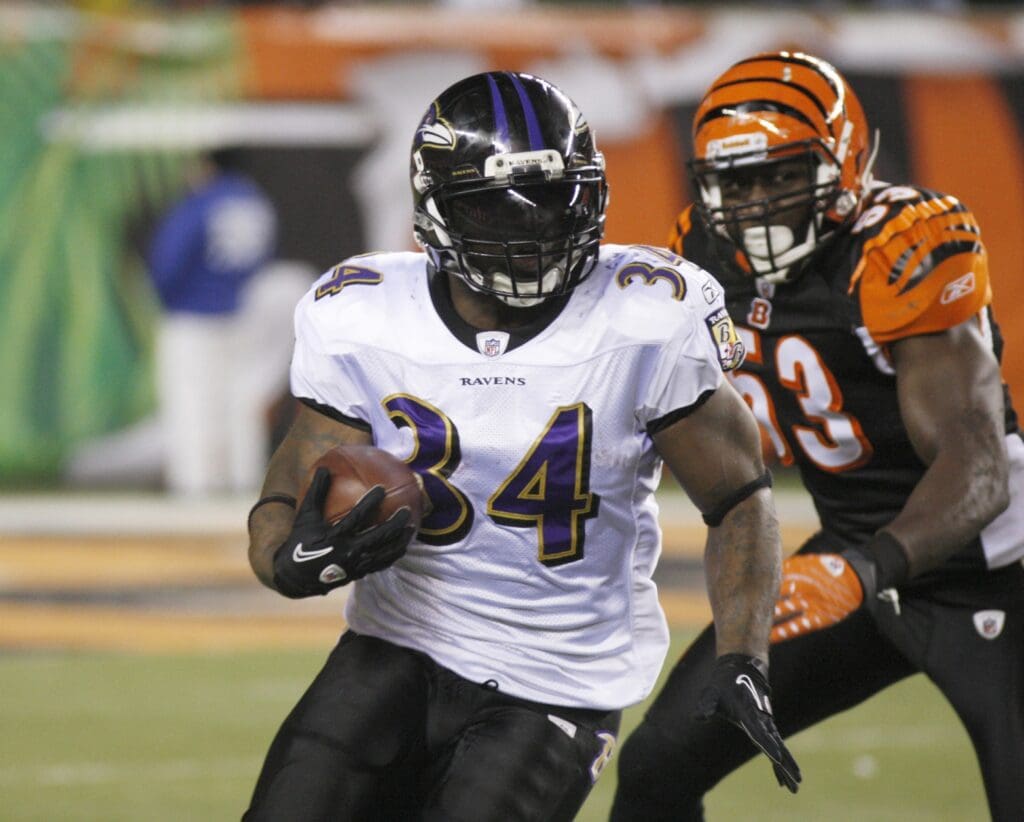 Jan 1, 2012; Cincinnati, OH USA; Baltimore Ravens running back Ricky Williams (34) runs against Cincinnati Bengals outside linebacker Thomas Howard (53) during the second half at Paul Brown Stadium. The Ravens won 24-16.