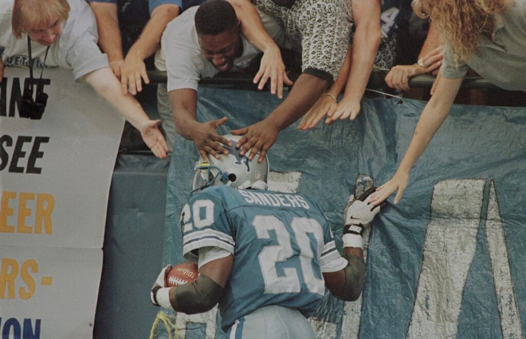 Barry Sanders celebrates with fans after a touchdown against the Tampa Bay Buccaneers in Detroit on September 9, 1996. Sanders Gets Handsa