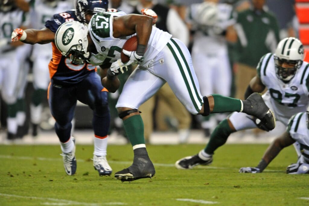 Nov 17, 2011; Denver, CO, USA; New York Jets inside linebacker Bart Scott (57) picks up a fumble by running back Denver Broncos Willis McGahee (23) (not pictured) during the first quarter at Sports Authority Field