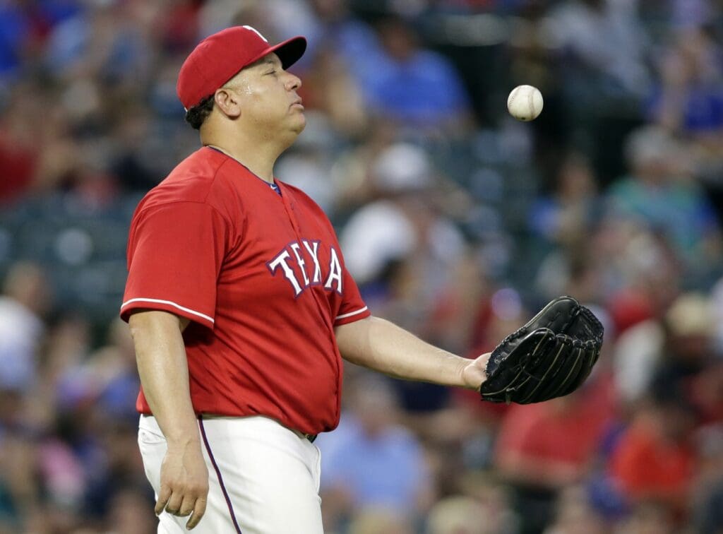 Aug 7, 2018; Arlington, TX, USA; Texas Rangers starting pitcher Bartolo Colon (40) reacts after a run is scored in the fifth inning against the Seattle Mariners at Globe Life Park in Arlington.