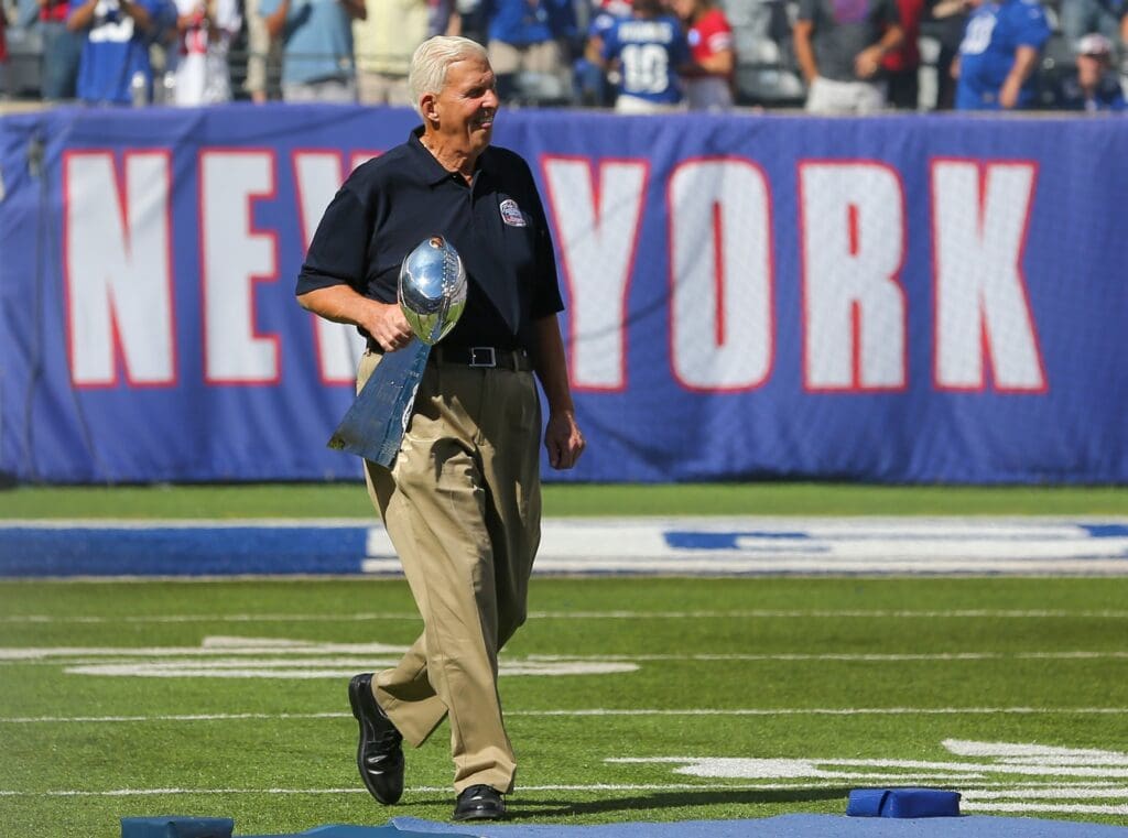 Sep 20, 2015; East Rutherford, NJ, USA; Former New York Giants head coach Bill Parcells carries the Vince Lombardi trophy from Super Bowl XXV during half time ceremony honoring the 25th anniversary of their championship at MetLife Stadium.