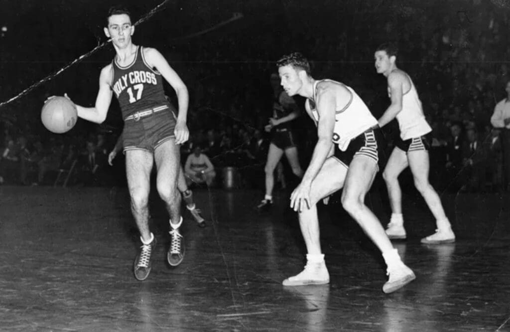 DATE UNKNOWN; FILE PHOTO; Bob Cousy takes the ball upcourt for Holy Cross.
