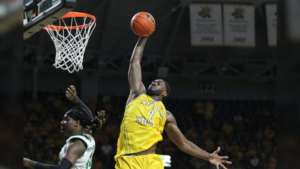 AfterShocks' Rashard Kelly (8) dunks the ball over Team Challenge ALS' Bobby Jones (15) during their TBT game at Koch Arena Tuesday, July 20, 2021. The AfterShocks defeated Challenge ALS 69-65. Hut 072221 Tbt 2