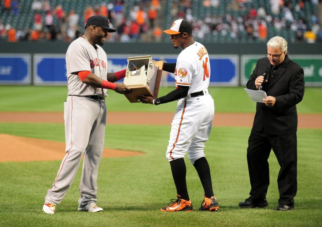 Sep 22, 2016; Baltimore, MD, USA; Boston Red Sox designated hitter David Ortiz (34) is presented with a broken phone by Baltimore Orioles outfielder Adam Jones (10) prior to the game at Oriole Park at Camden Yards.