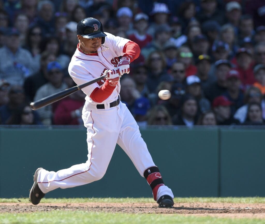 Apr 17, 2016; Boston, MA, USA; Boston Red Sox right fielder Mookie Betts (50) hits an RBI single during the fourth inning against the Toronto Blue Jays at Fenway Park.