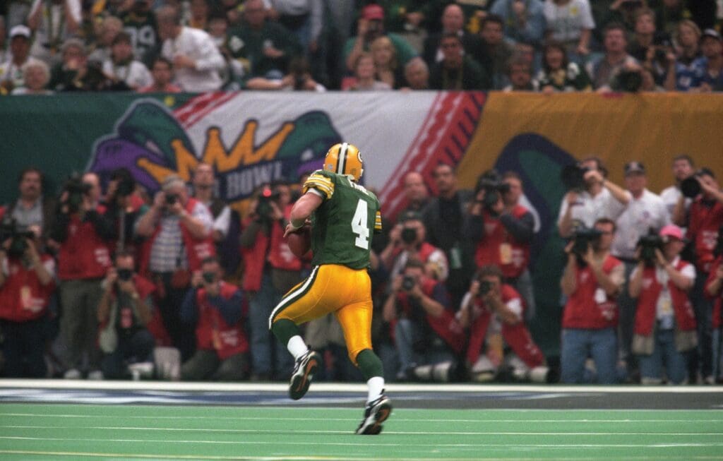 Jan 26, 1997; New Orleans, LA, USA; FILE PHOTO; Green Bay Packers quarterback Brett Favre (4) scrambles for the endzone against the New England Patriots during Super Bowl XXXI at the Superdome. The Packers defeated the Patriots 35-21.
