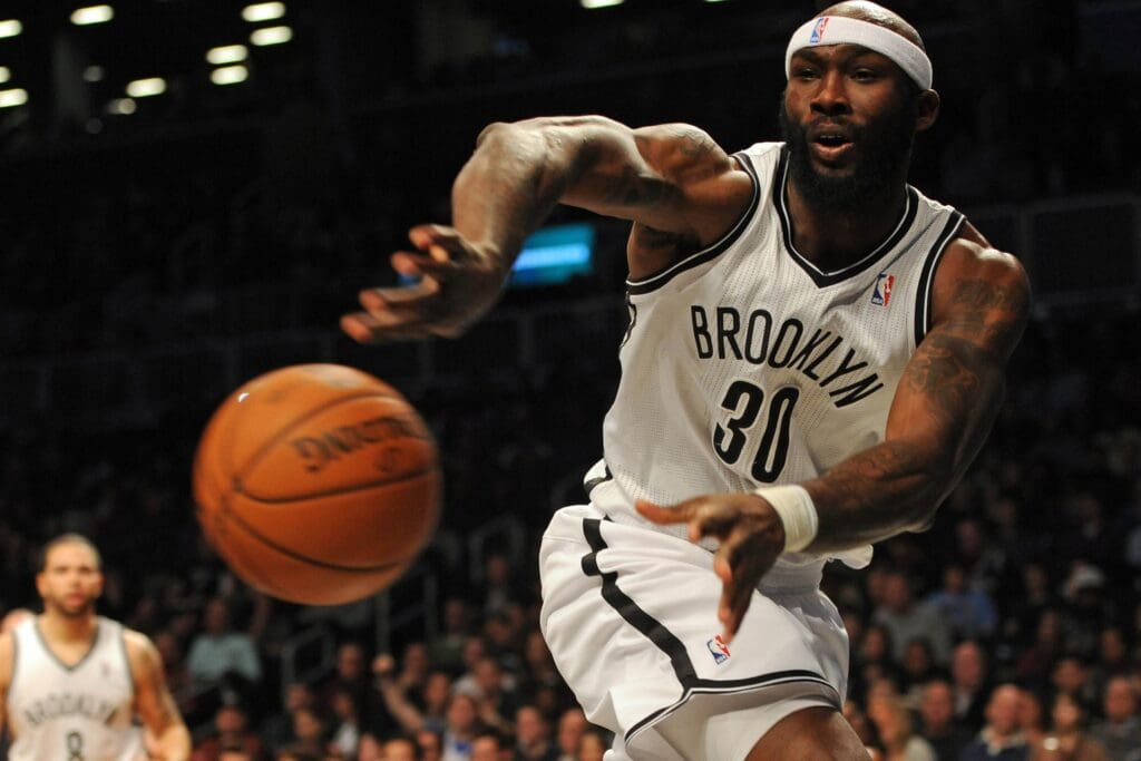 Dec 23, 2012; Brooklyn, NY, USA; Brooklyn Nets forward Reggie Evans (30) makes a pass against the Philadelphia 76ers during the first half at the Barclays Center.