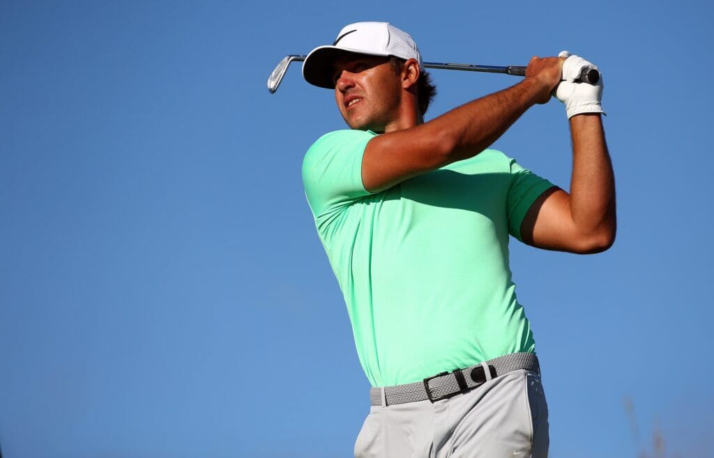 Jun 18, 2017; Erin, WI, USA; Brooks Koepka plays his shot from the 15th tee during the final round of the U.S. Open golf tournament at Erin Hills.