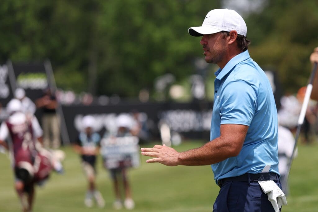 Jun 6, 2025; Gainesville, Virginia, USA; Brooks Koepka of team Smash GC waves to the crowd after making a putt on the third hole during the first round of the LIV Golf Virginia golf tournament at Robert Trent Jones Golf Club.